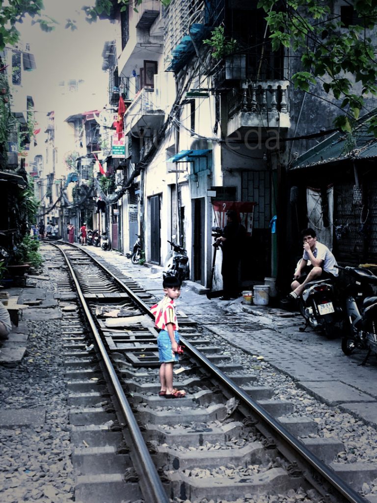One scene at Hanoi, standing boy on the rail track, Viet-Nam, Yuji Ikeda Photo